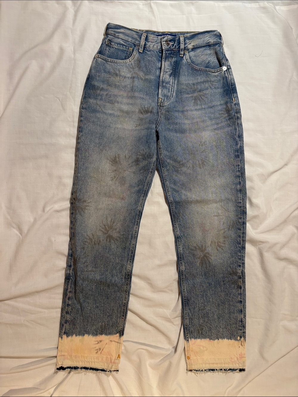 Scotch & Soda Faded Blue Relaxed Jeans with Bleached Hem and “watermark” designs